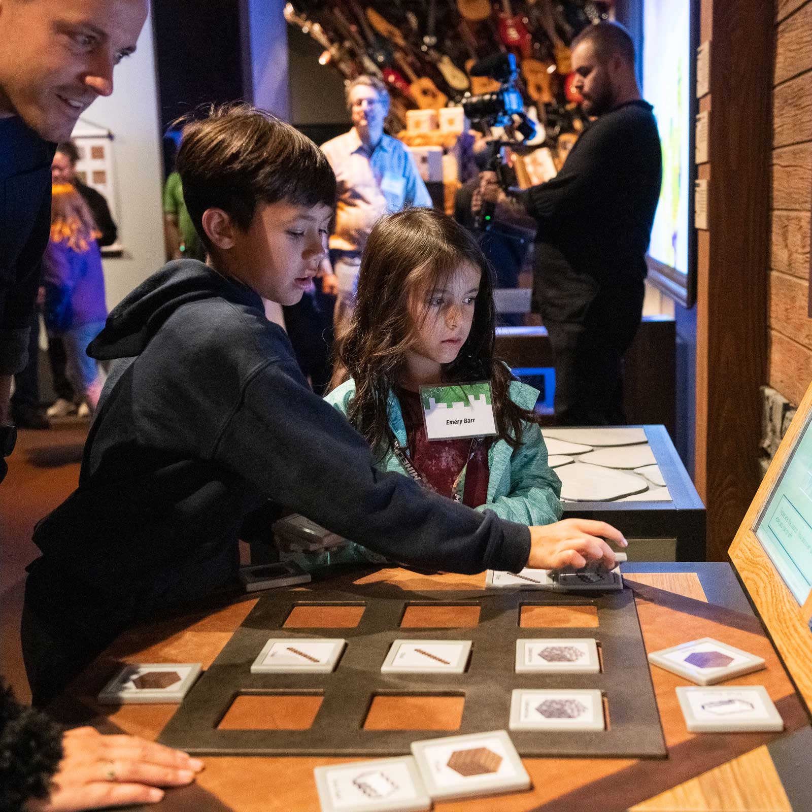 Kids using MoPOP's 'Minecraft: The Exhibition' physical crafting table